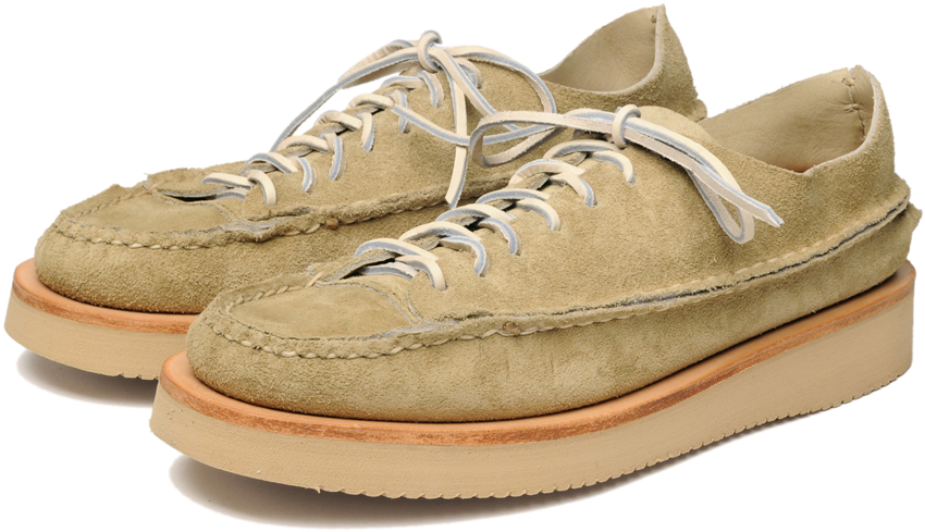 A Pair Of Tan Shoes With White Laces