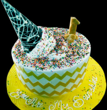 A Cake With Sprinkles And A Cone On Top