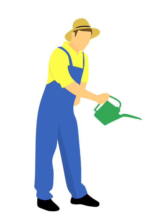 A Man In Overalls Holding A Watering Can
