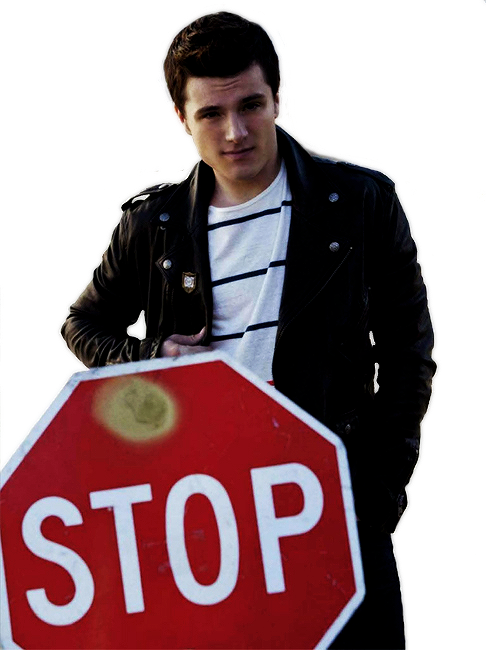 A Man Standing Next To A Stop Sign