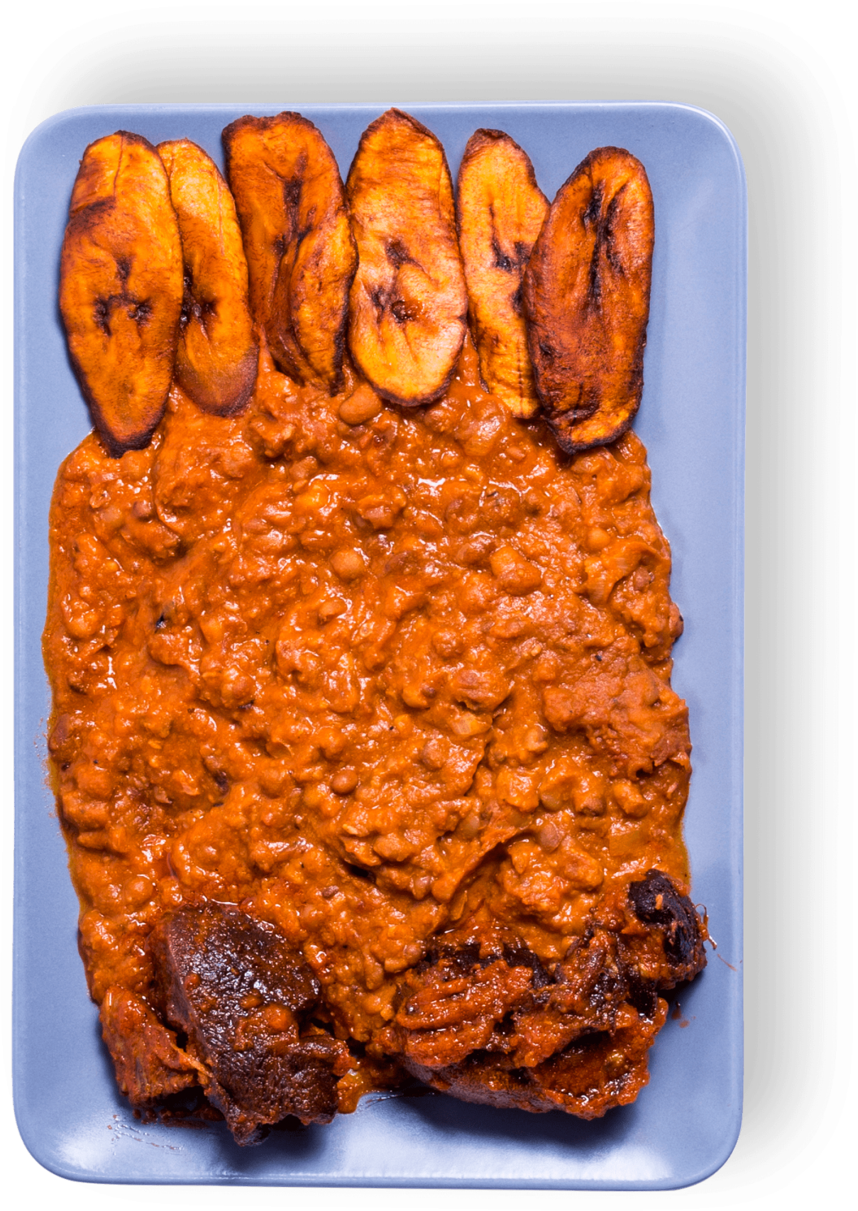 A Plate Of Food With Meat And Plantains