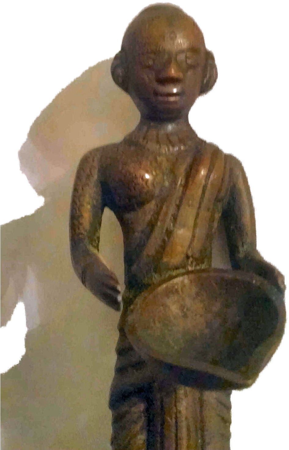 A Statue Of A Man Holding A Bowl