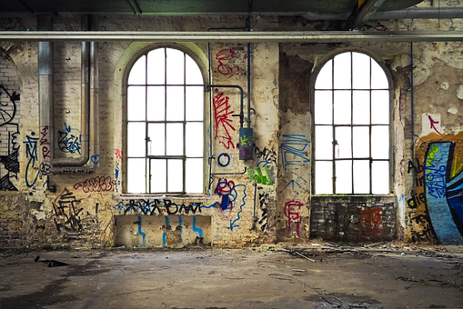 A Room With Windows And Graffiti On The Wall