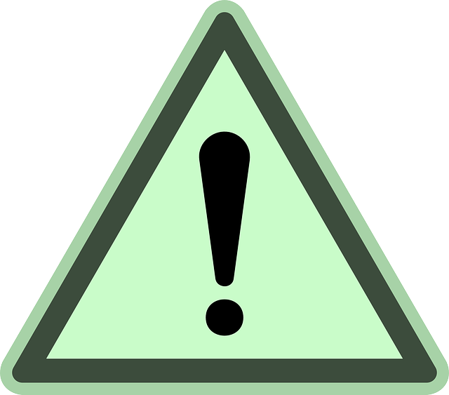 A Green Triangle With A Exclamation Mark