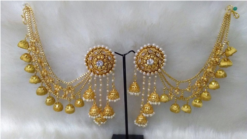 A Pair Of Gold Earrings With Pearls And Diamonds