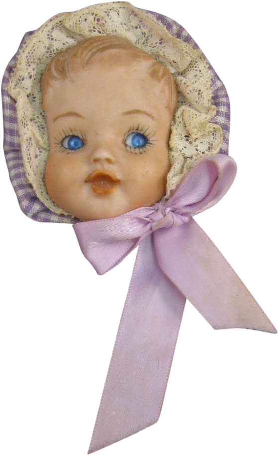 A Doll Head With Blue Eyes And A Purple Bow