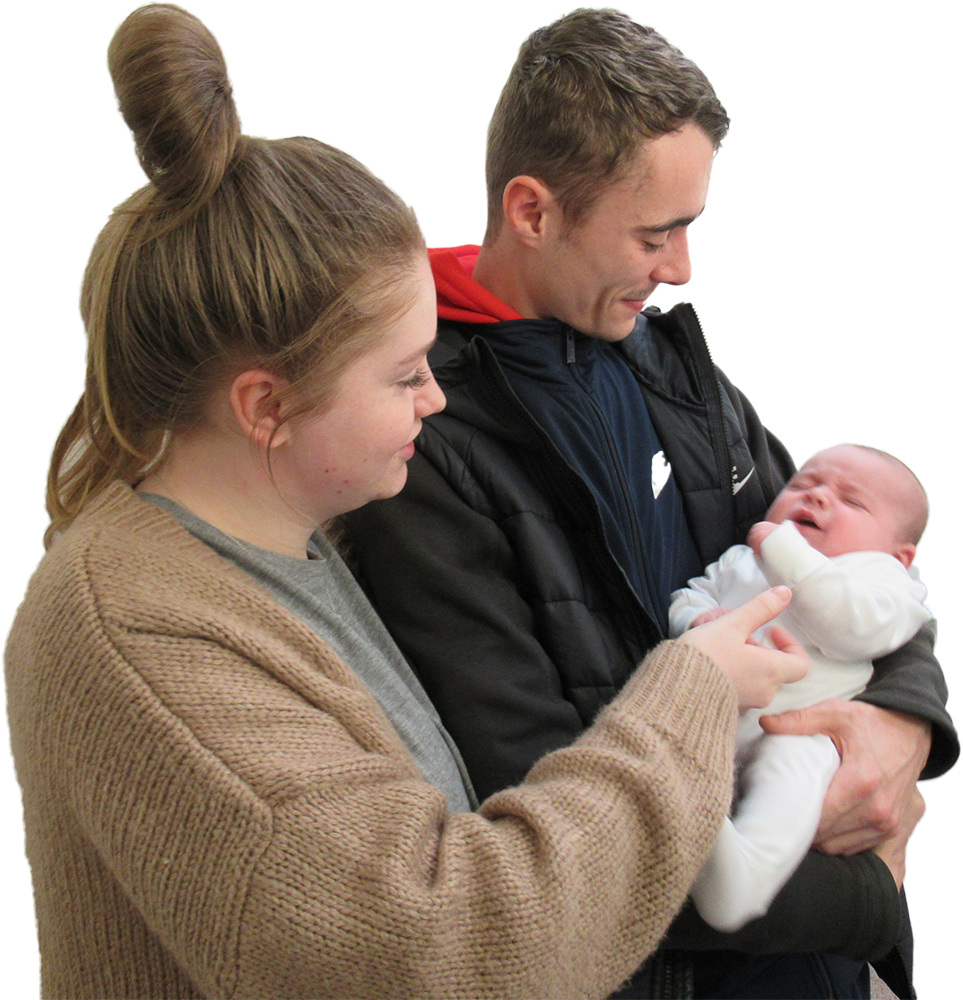 A Man And Woman Holding A Baby