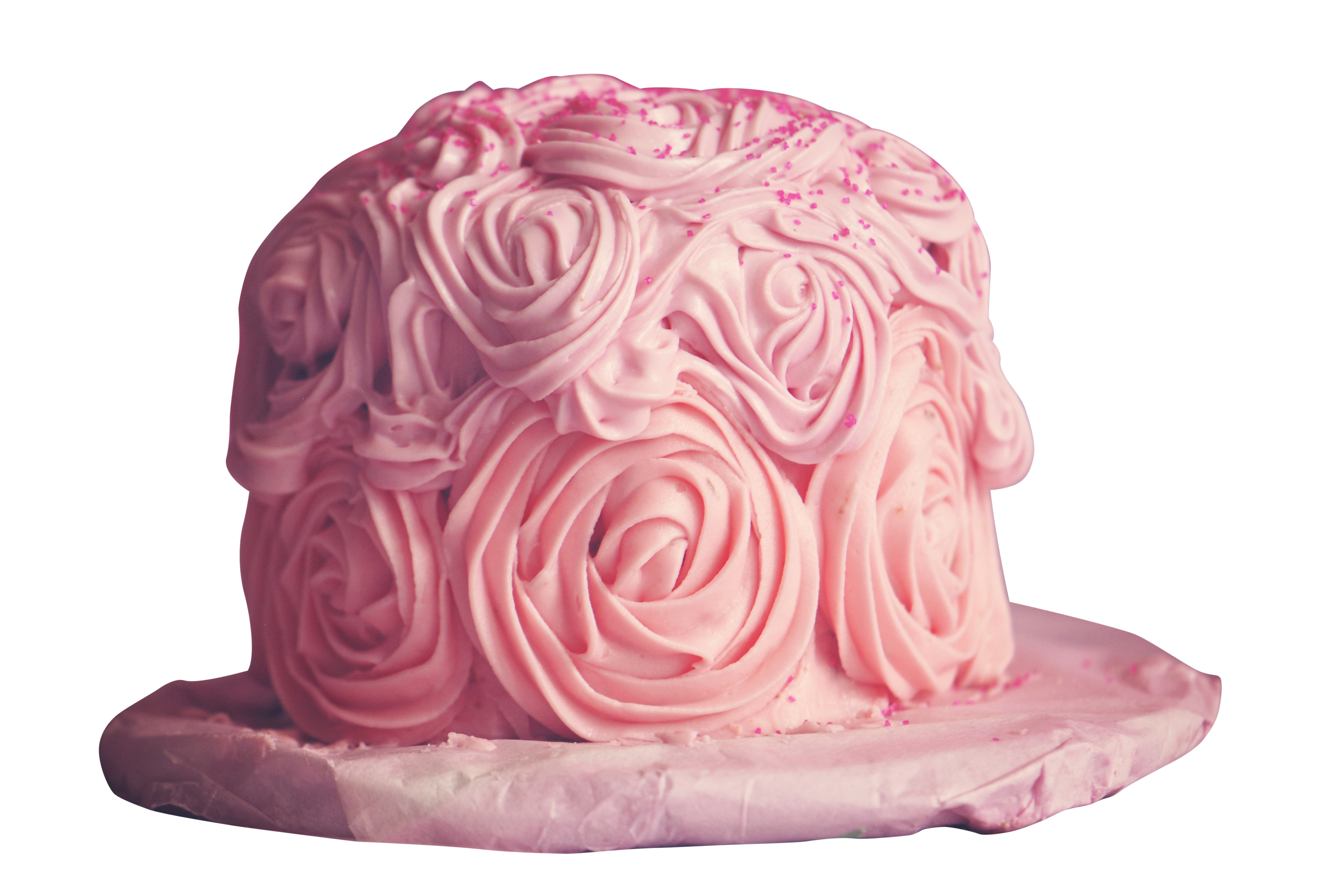 A Cake With Pink Frosting And Pink Sprinkles