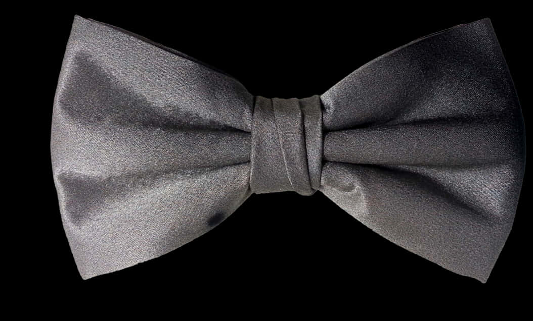 A Grey Bow Tie On A Black Background