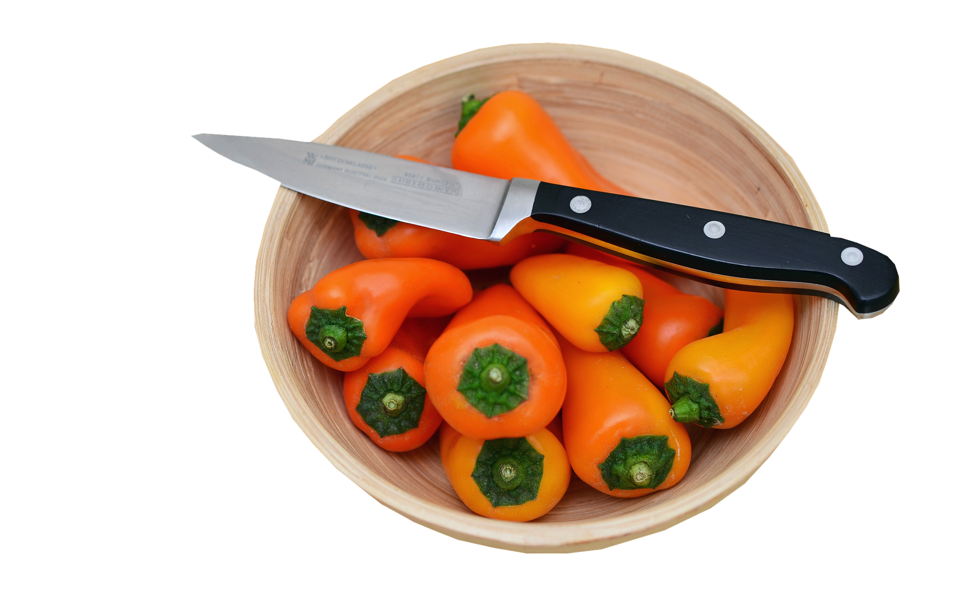A Bowl Of Orange Peppers And A Knife