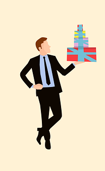 A Man In A Suit Holding A Stack Of Presents