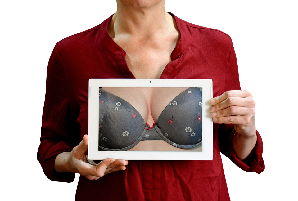 A Woman Holding A Tablet With A Picture Of A Garment