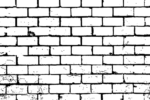 A White Brick Wall With Black Spots