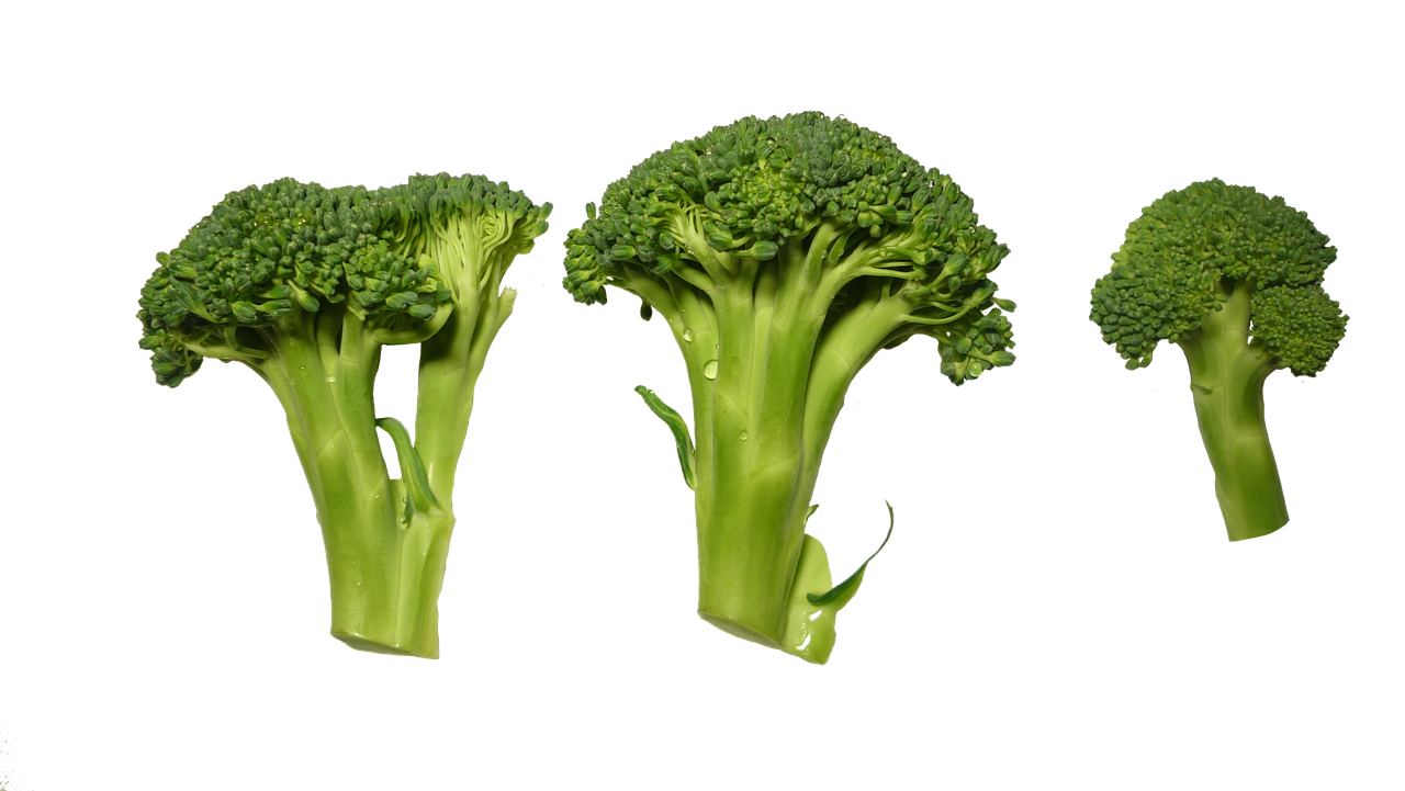 A Group Of Broccoli On A Black Background