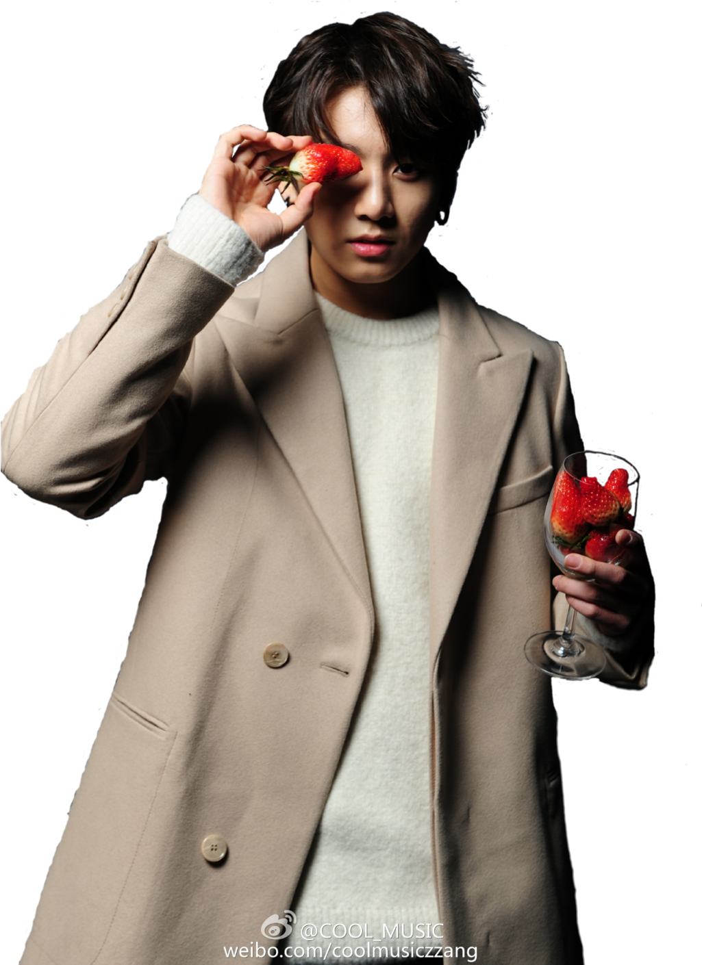 A Person Holding Strawberries And A Wine Glass