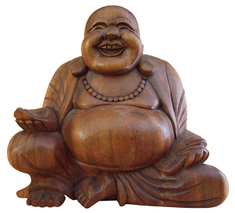 A Wood Carving Of A Smiling Buddha