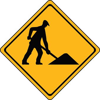 A Yellow Sign With A Man Digging A Pile Of Sand