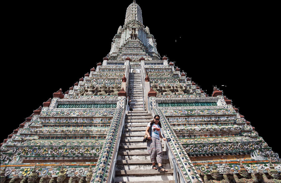 A Woman Standing On Stairs Of A Temple With Wat Arun In The Background