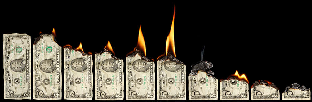 A Row Of Paper Money On Fire