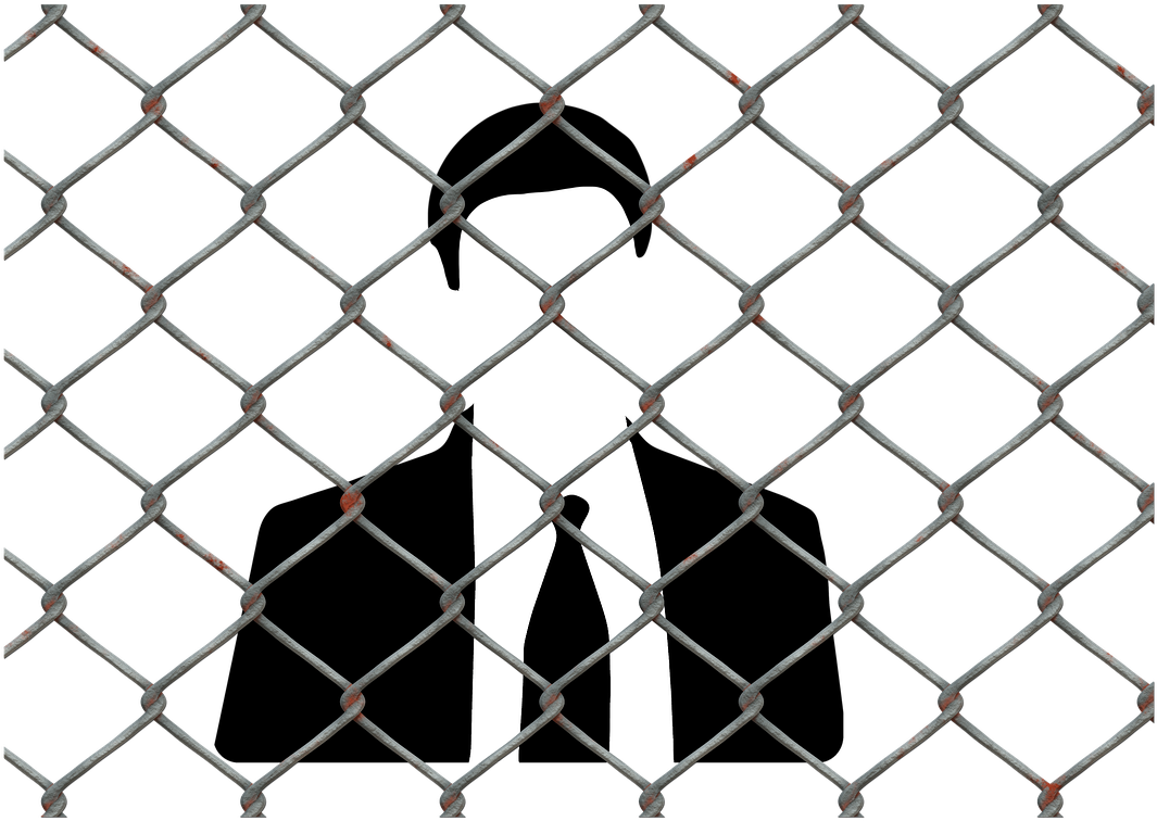 A White Silhouette Of A Person Behind A Chain Link Fence