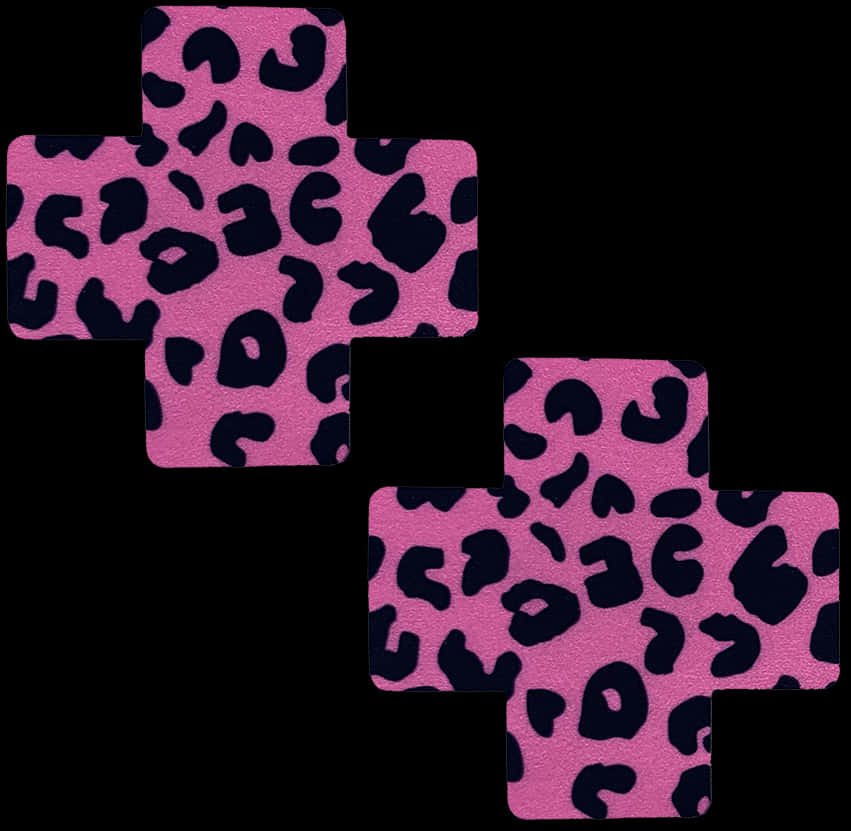 A Pink And Black Cross With Black Spots