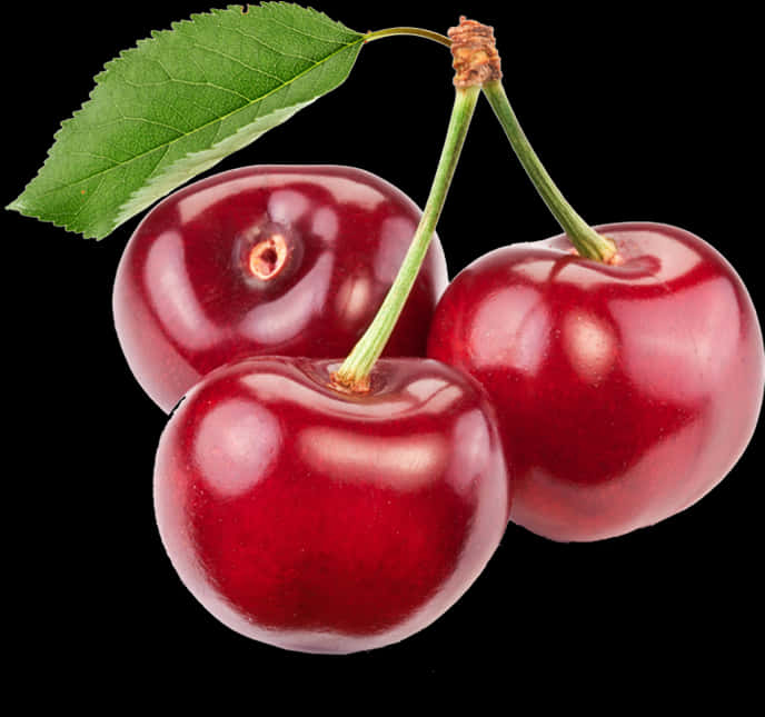 A Group Of Cherries With A Leaf