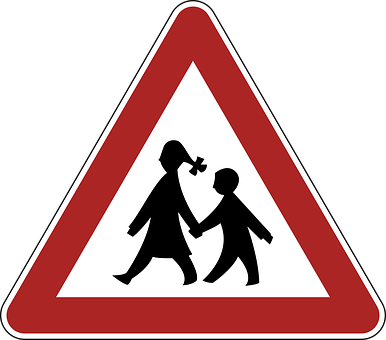 A Red Triangle Sign With Black Silhouettes Of People Walking