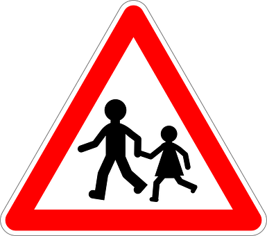A Red And White Triangle Sign With A Couple Of People Walking