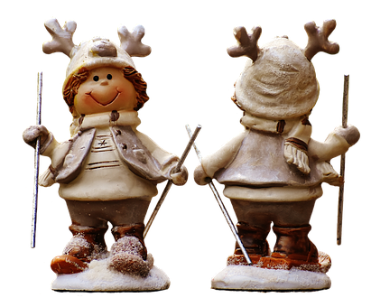Two Figurines Of A Boy And Girl On Skis