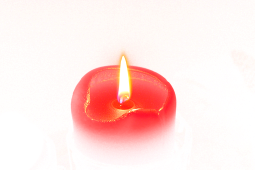 A Red Candle With A Flame