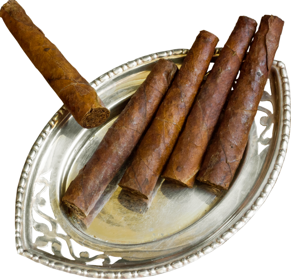 A Group Of Cigars On A Silver Plate