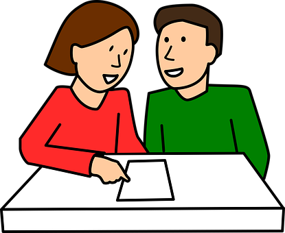 A Man And Woman Sitting At A Table Looking At A Piece Of Paper