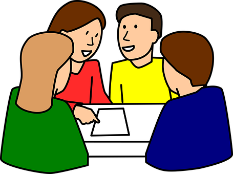 A Group Of People Sitting Around A Table