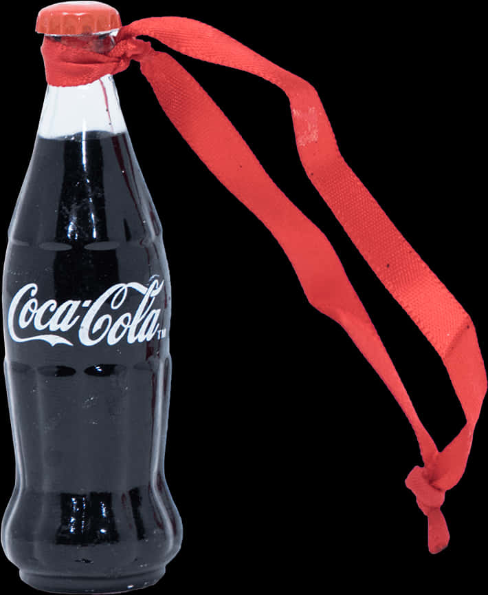 A Bottle Of Soda With A Red Ribbon