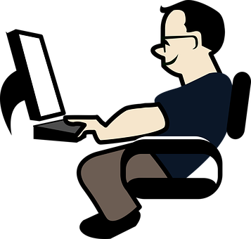 A Man Sitting In A Chair Using A Laptop