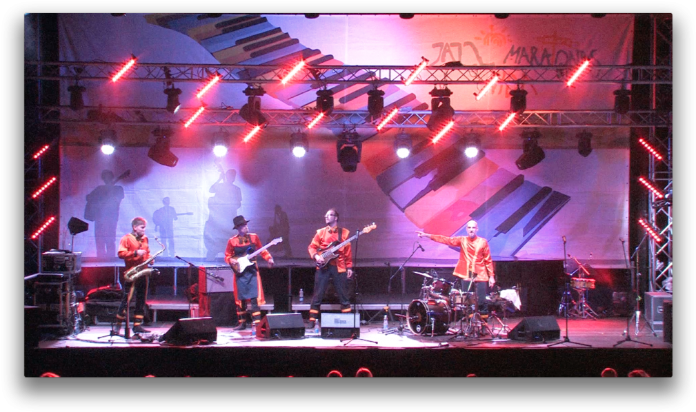 A Group Of People On A Stage Playing Instruments