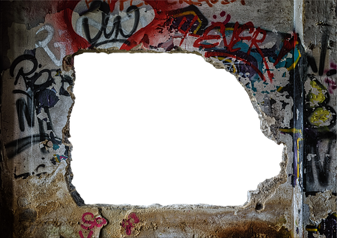 A Hole In A Wall With Graffiti