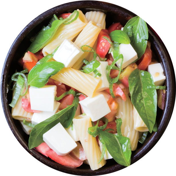 A Bowl Of Pasta With Cheese And Basil