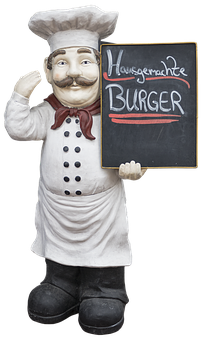 A Statue Of A Chef Holding A Blackboard
