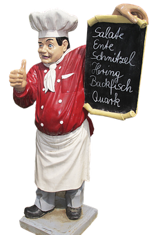 A Statue Of A Chef Holding A Blackboard