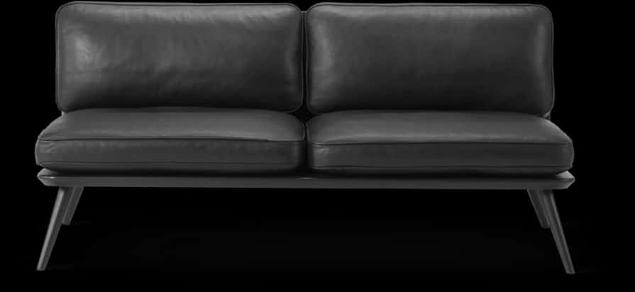 A Black Leather Couch With A Black Background