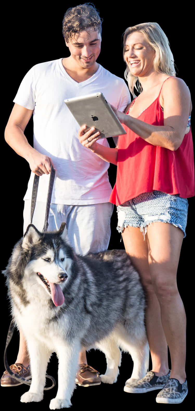 A Man And Woman Standing Next To A Dog