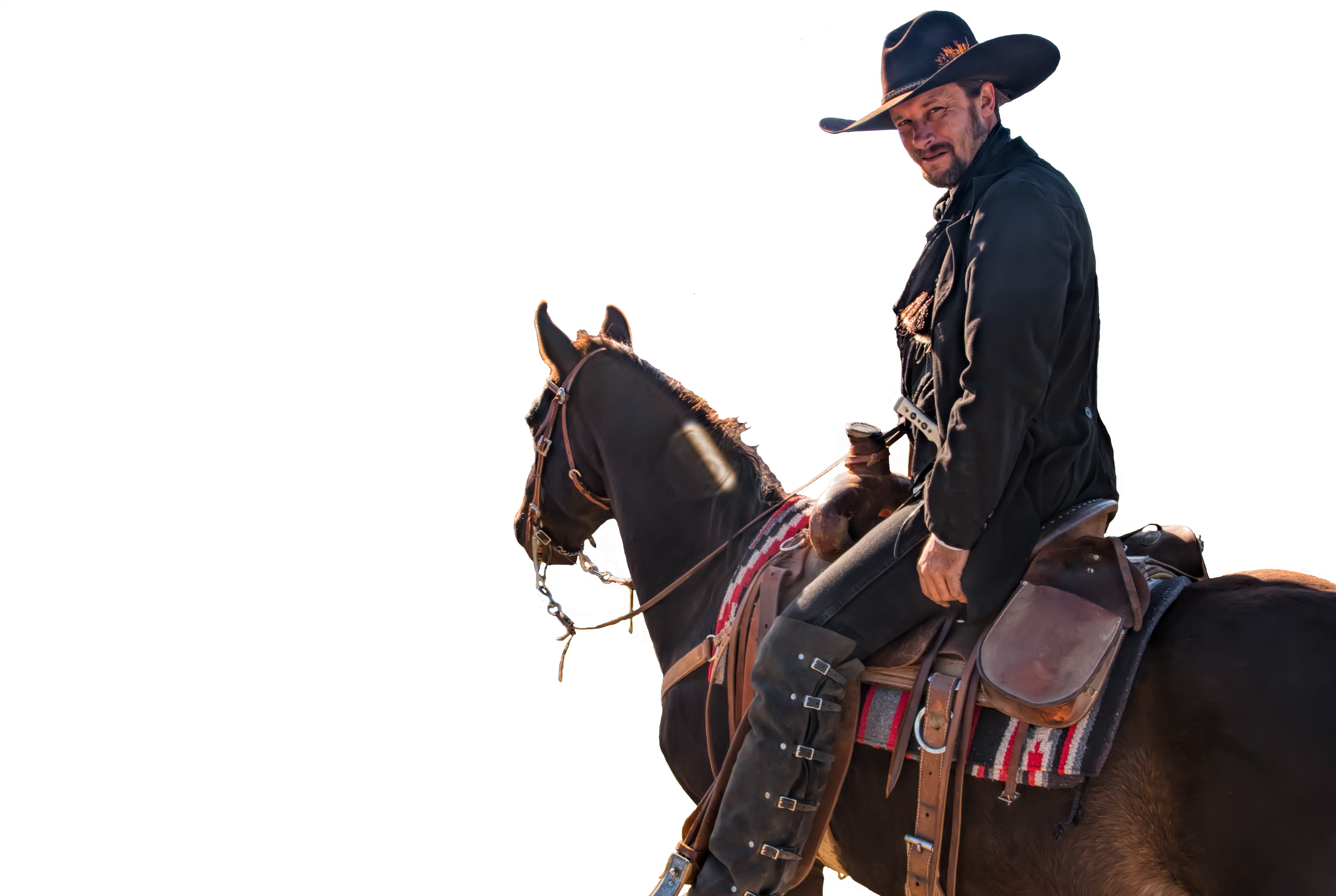 A Man In A Cowboy Hat Sitting On A Horse