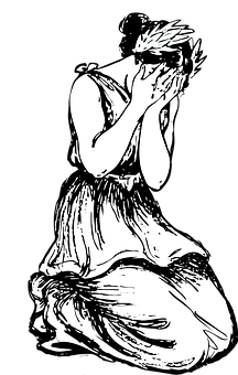 A Woman Kneeling In Prayer