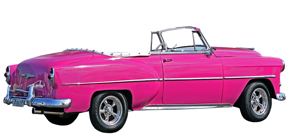 A Pink Convertible Car With A Black Background