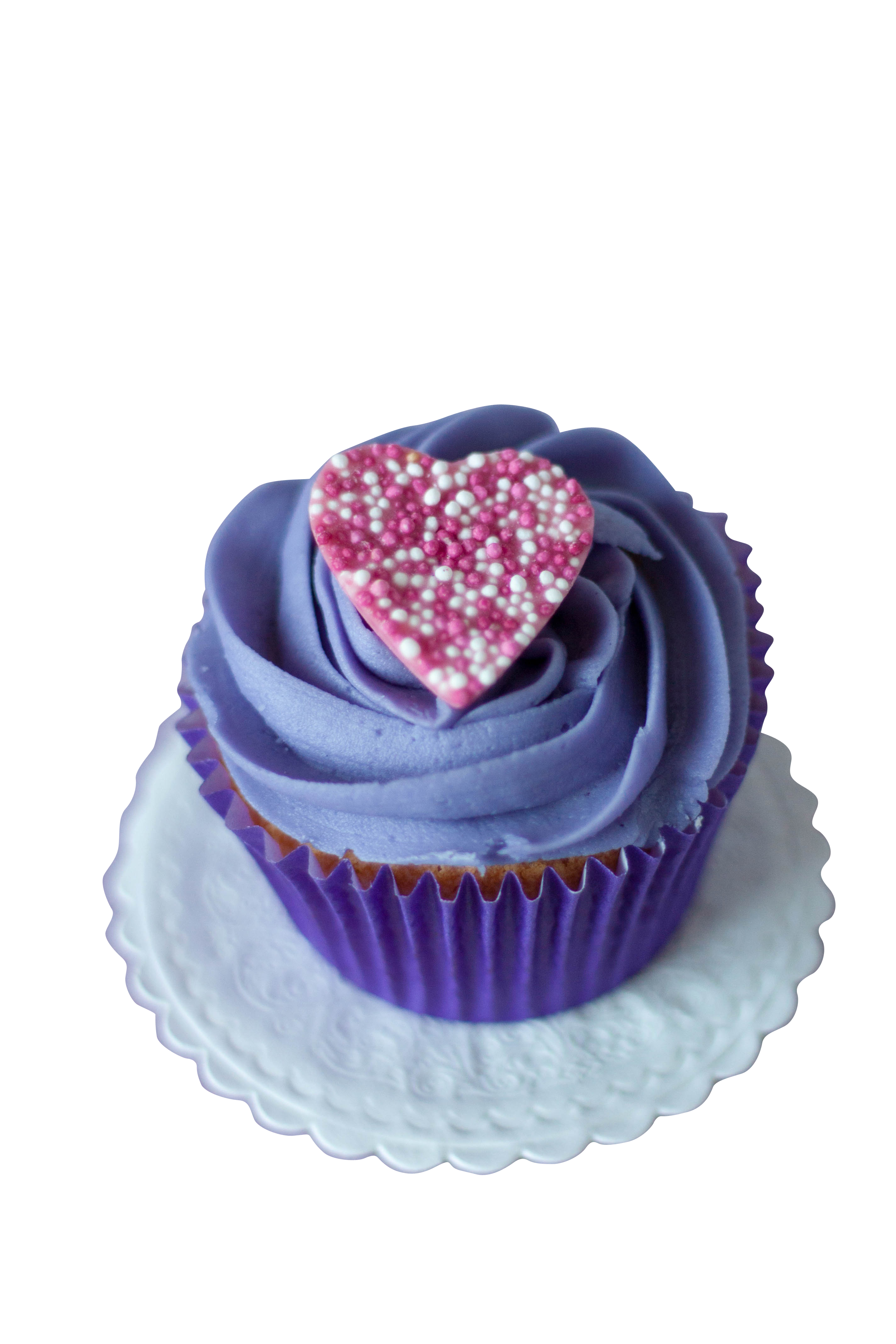 A Cupcake With Purple Frosting And A Heart On Top