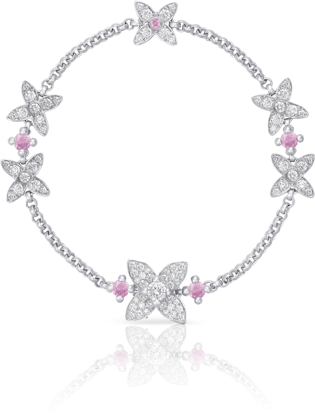 A Silver Bracelet With Pink Stones And A Flower