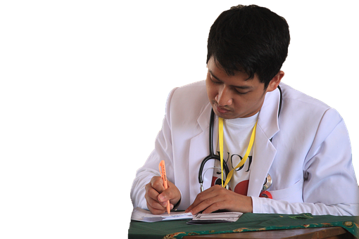 A Man In A White Coat Writing On A Piece Of Paper