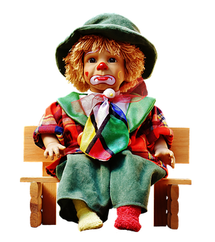 A Doll Sitting On A Bench