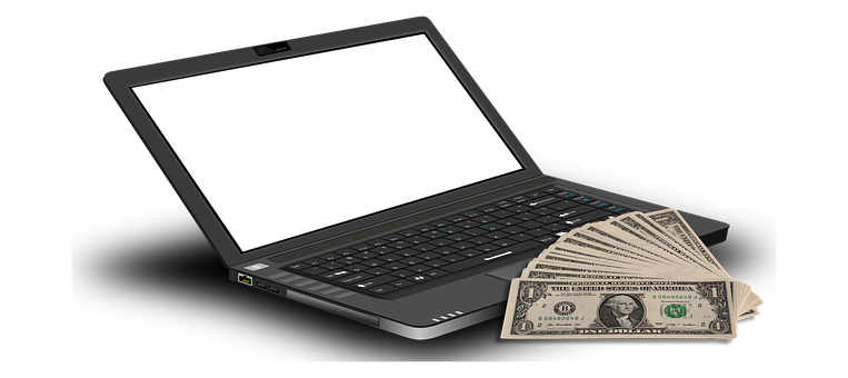 A Laptop With Money On The Keyboard